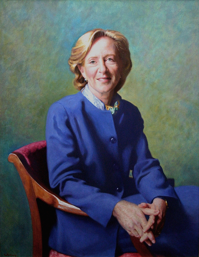 commissioned portrait of a woman sitting down in a blue pants suit, fingers intertwined. 